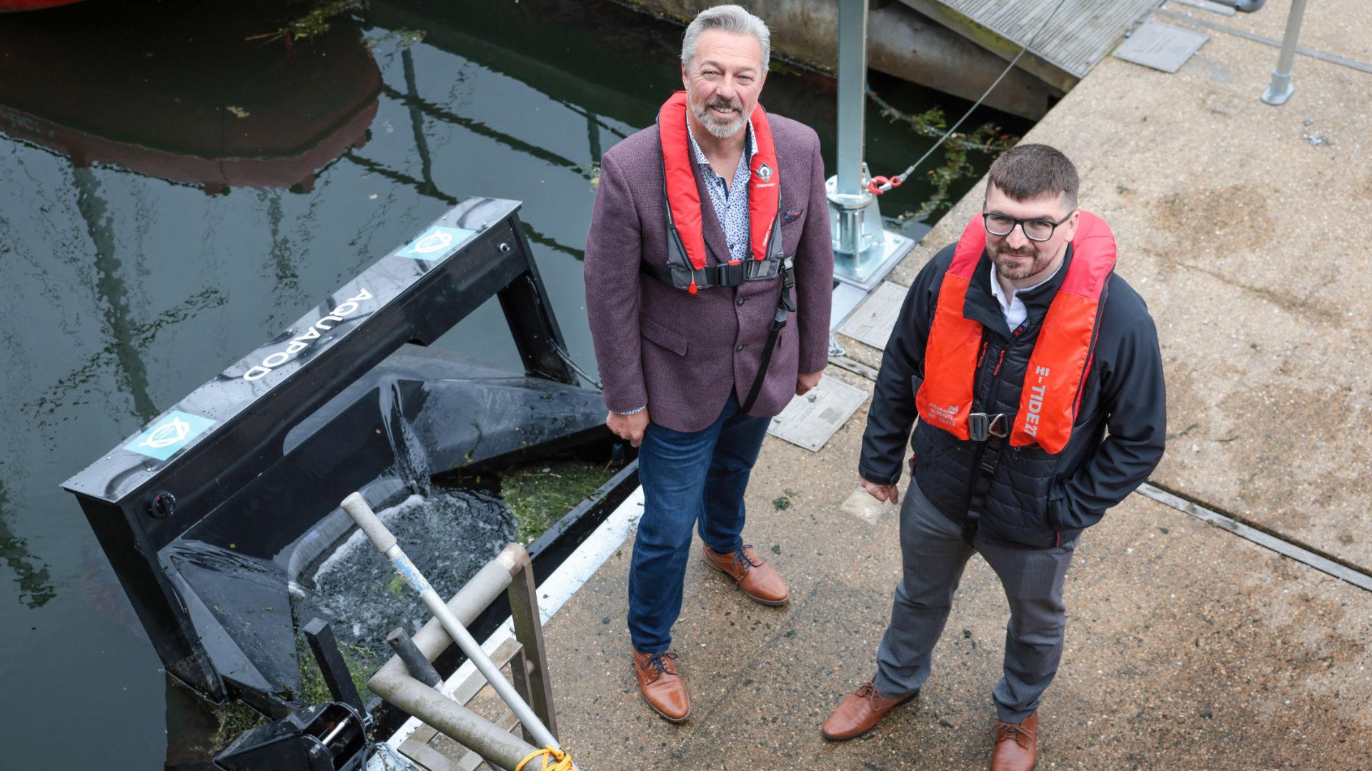 Alan Branagh of NETZERO Alchemists on the pontoon beside a deployed Aquapod at Belfast Harbour Marina